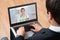 Businessperson Videochatting Online With Doctor On Laptop