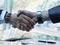 Businessteam of deal which handshake man and Success concept of handshaking after successful deal job While dollars banknote