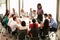 Businesswoman Addressing Meeting Around Boardroom Table