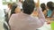 Businesswoman Addressing Meeting Around Boardroom Table