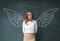 Businesswoman with angel wings