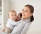 Businesswoman with baby and smartphone at office