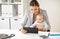 Businesswoman with baby and tablet pc at office