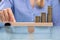 Businesswoman Balancing Stacked Coins With Finger