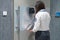 Businesswoman bank employee  bank vault door typing security code for alarm system