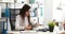 Businesswoman in black glasses filling documents and working on laptop in modern office.