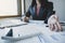 Businesswoman bookkeeper hand holding pen and analysis the graph with calculator and laptop at the home office for setting