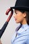 Businesswoman in bowler hat with umbrella.