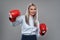 Businesswoman with boxing gloves in fight mood