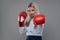 Businesswoman with boxing gloves in fight mood