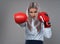 Businesswoman with boxing gloves in fight mood