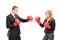 Businesswoman with boxing gloves having a fight with a businessman