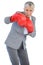 Businesswoman boxing with her boxing gloves