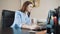 Businesswoman brunette sitting in the office and working on the computer.