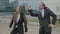 Businesswoman and business man wearing formal clothes funny dancing like crazy outside the corporation after leaving work