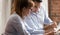 Businesswoman and businessman discussing paperwork holding documents at business meeting