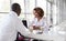 Businesswoman and businessman at a meeting, talking