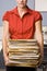 Businesswoman carrying stack of file folders