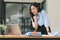 A businesswoman celebrates with her arms up while looking a laptop in a happy and successful pose.