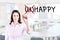 Businesswoman choosing Happy instead of Unhappy. Office background.