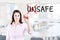 Businesswoman choosing Safe instead of Unsafe. Office background.