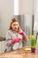 Businesswoman cleaning the kitchen on weekend sneezing