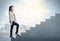 Businesswoman climbing up a concrete staircase concept