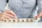 Businesswoman collected business word with wooden cubes