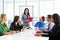 Businesswoman Conducting Meeting In Boardroom