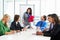 Businesswoman Conducting Meeting In Boardroom