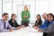 Businesswoman Conducting Meeting In Boardroom