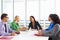 Businesswoman Conducting Meeting In Boardroom