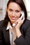 Businesswoman conversing on landline phone, portrait