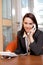 Businesswoman conversing on landline phone, portrait