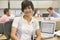 Businesswoman in cubicle smiling