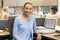 Businesswoman in cubicle smiling