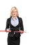 Businesswoman cutting a red ribbon