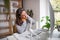 Businesswoman at the desk indoors in office, feeling pain in neck.