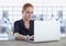 Businesswoman at desk with laptop and grid chart points