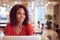 Businesswoman At Desk In Modern Office Work Space With Laptop