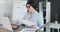 Businesswoman doing paperwork at office desk