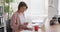 Businesswoman drinking coffee while working at office desk