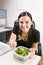 Businesswoman eating salad at desk