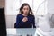 Businesswoman Enjoying Breeze With Electric Fan