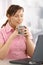 Businesswoman enjoying tea at desk