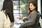 Businesswoman enjoys talking with her colleague while working in the office