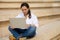 Businesswoman, entrepreneur freelance worker online working on laptop while sitting on steps. People. Business. Career