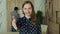 Businesswoman extending hand at camera, offering handshake, greeting guests, looking at camera