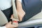 Businesswoman fastening seat belt in car before driving