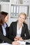 Businesswoman With Female Coworker At Desk